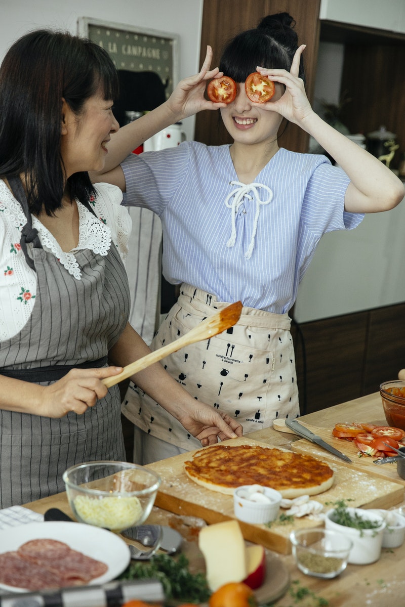 Cheerful women having fun in kitchen