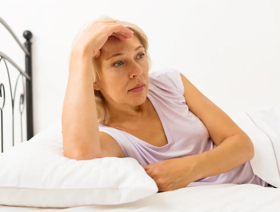 What causes vaginal discharge after menopause?